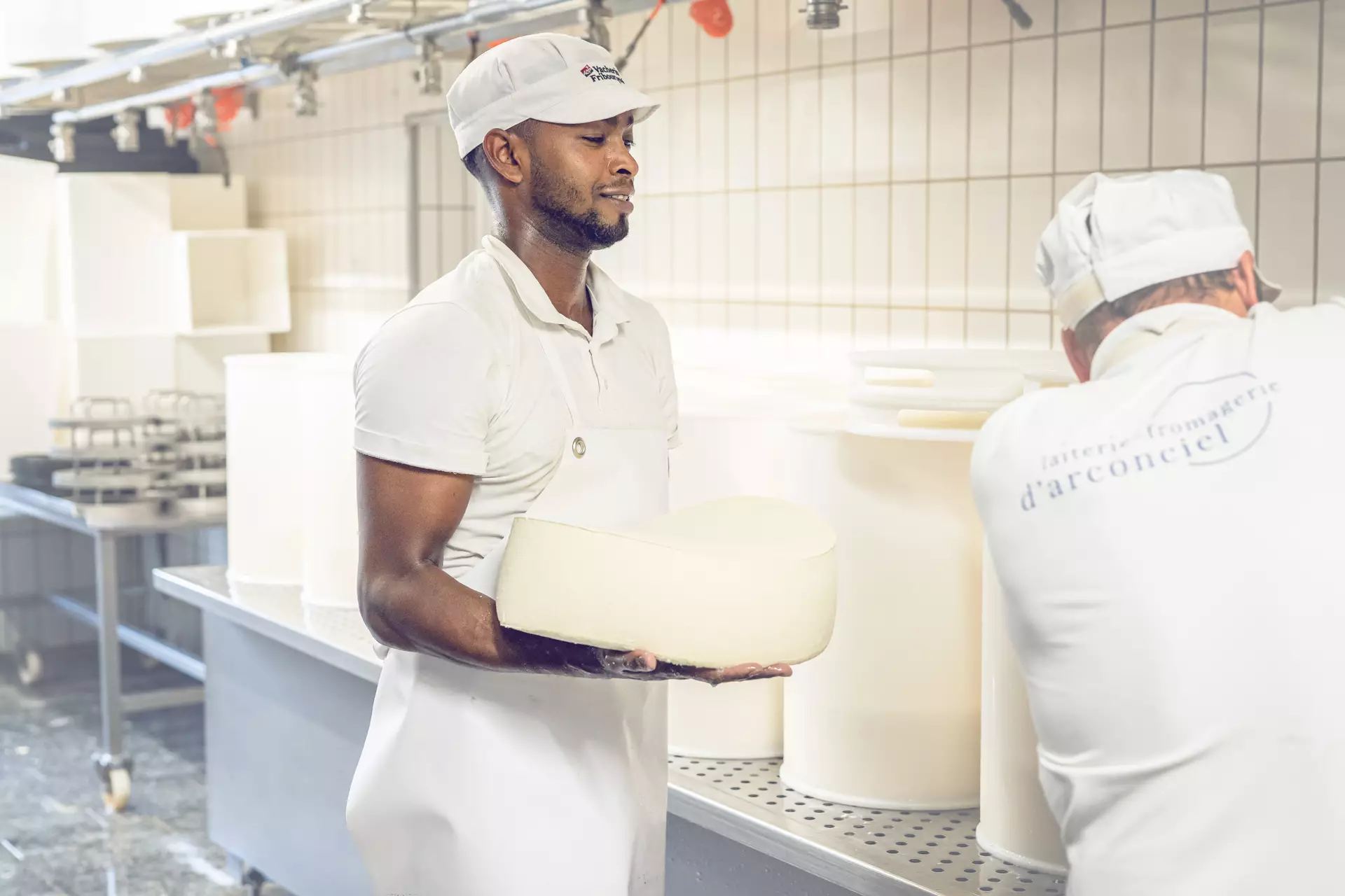 Apprenti fromager et un collègue travaillant 